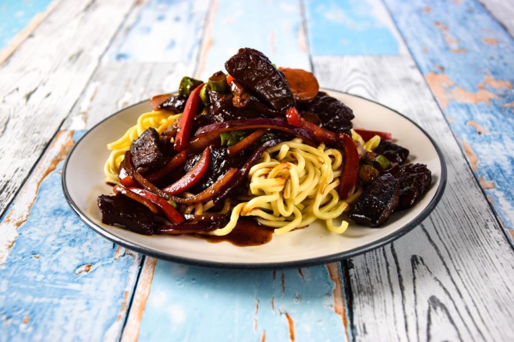 Wild boar cooked in soy and ginger served with noodles.