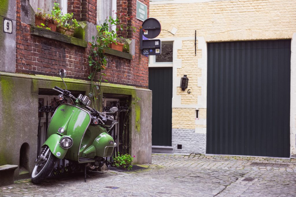 Bright Green Moped parked outside a flat. Picture by Alex