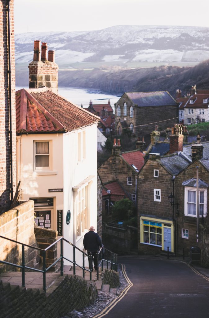 A man walks down steps in a seaside town. Picture by Tom Kulczycki